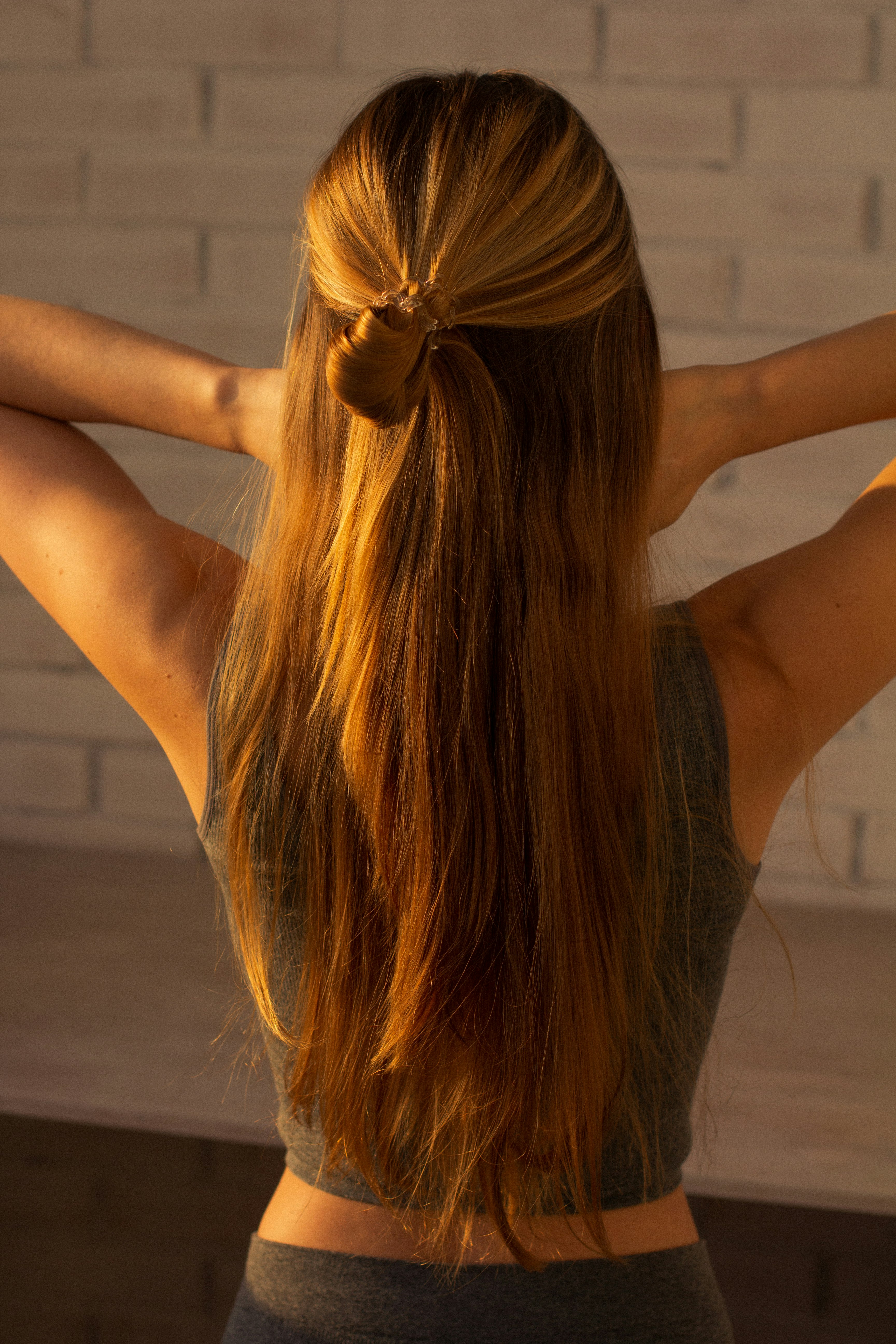 woman in black tank top raising her hands